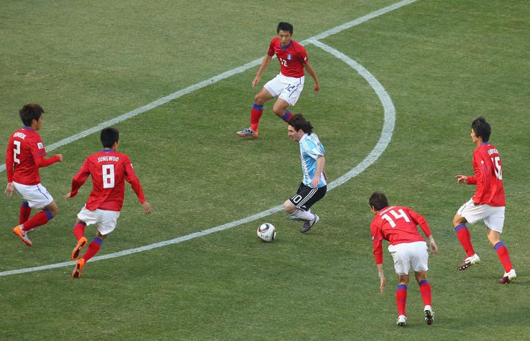 JOHANNESBURG, SOUTH AFRICA - JUNE 17:  Lionel Messi of Argentina takes on the South Korea defence during the 2010 FIFA World Cup South Africa Group B match between Argentina and South Korea at Soccer City Stadium on June 17, 2010 in Johannesburg, South Africa.  (Photo by Cameron Spencer/Getty Images)