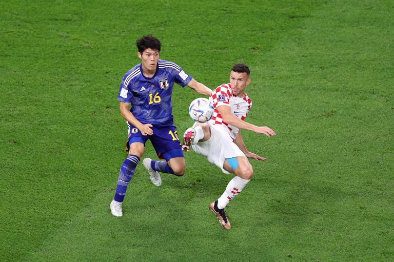 AL WAKRAH, QATAR - DECEMBER 05: Ivan Perisic of Croatia battles for possession with Takehiro Tomiyasu of Japan during the FIFA World Cup Qatar 2022 Round of 16 match between Japan and Croatia at Al Janoub Stadium on December 05, 2022 in Al Wakrah, Qatar. (Photo by Elsa/Getty Images)