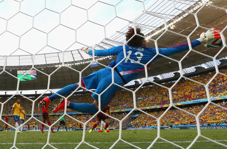 FORTALEZA, BRAZIL - JUNE 17: Guillermo Ochoa of Mexico dives to make a save during the 2014 FIFA World Cup Brazil Group A match between Brazil and Mexico at Castelao on June 17, 2014 in Fortaleza, Brazil. (Photo by Robert Cianflone/Getty Images)