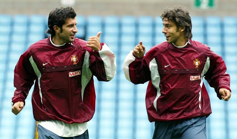 BIRMINGHAM, UNITED KINGDOM:  Portugese players Luis Figo (L) and Rui Costa (R) share a joke 06 September 2002, during training at Villa Park in preparation for tomorrows friendly International against England. AFP PHOTO GERRY PENNY (Photo credit should read GERRY PENNY/AFP via Getty Images)